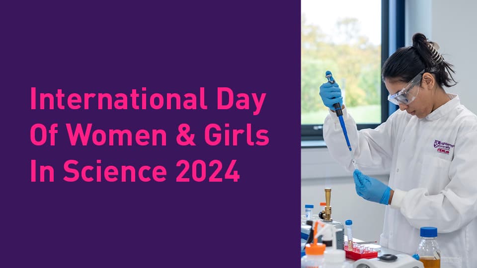 A poster promoting the International Day of Women & Girls in Science showing a picture of a female student using a pipette in a lab